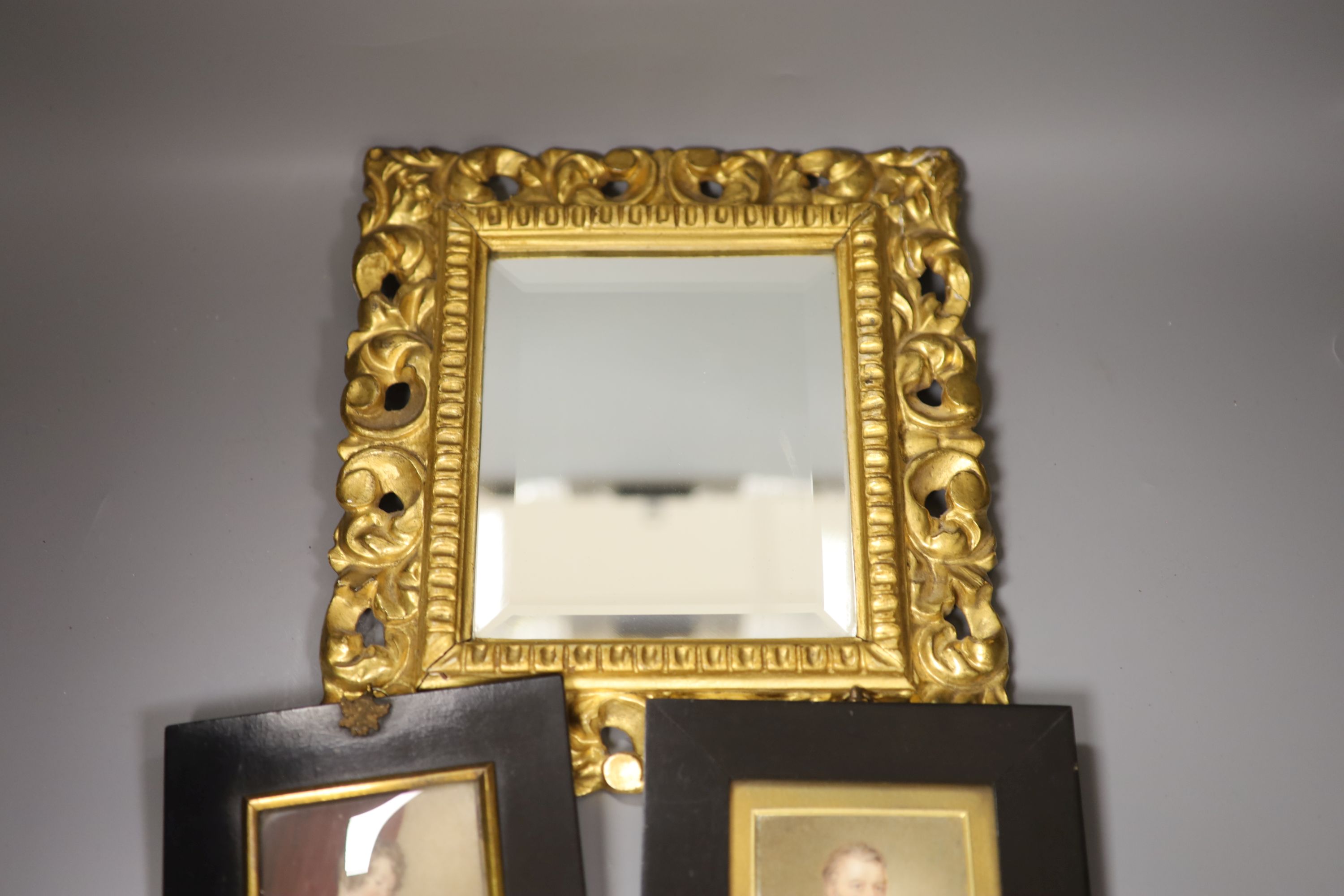 Four 19th century miniature portraits and a gilt-framed mirror, 26 x 29cm